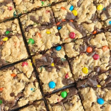 Monster Cookie Brownies | Monster Cookies | Brownies | Brookies | Monster cookie brownies start with a boxed brownie mix and then topped with a homemade monster cookie dough. Two desserts in one! Milk chocolate brownies and monster cookies loaded with peanut butter, oats, chocolate chips, and m&m's. #dessert #easydessertrecipes #brownies