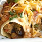 Ground Turkey Taco Roll-Ups | Mexican Food | Dinner Recipe | Tacos | Taco roll ups are made with ground turkey, spices, and veggies for a fun & delicious twist to taco night! Taco seasoned ground turkey with cream cheese gets rolled up in a flour tortilla and bakes in the oven. Creamy, delicious and easy to make taco roll ups are a family favorite. #easydinnerrecipes #easyrecipe #dinner #mexicanfood #tacos