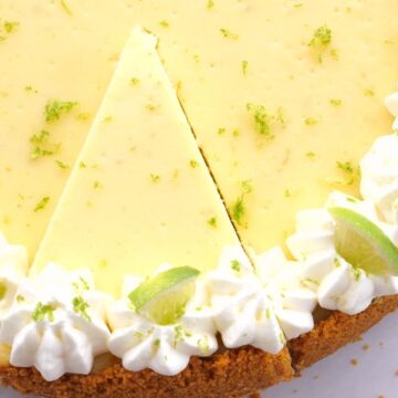 An overhead shot of key lime cheesecake with whipped cream garnish.
