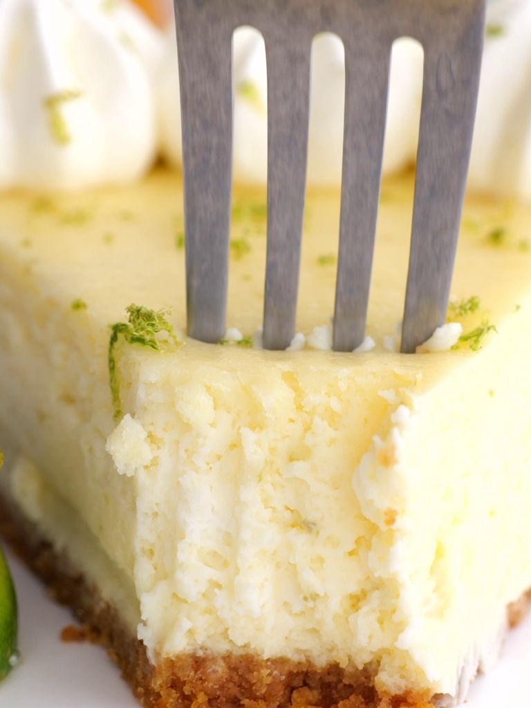 A piece of cheesecake with a fork sitting in it. 