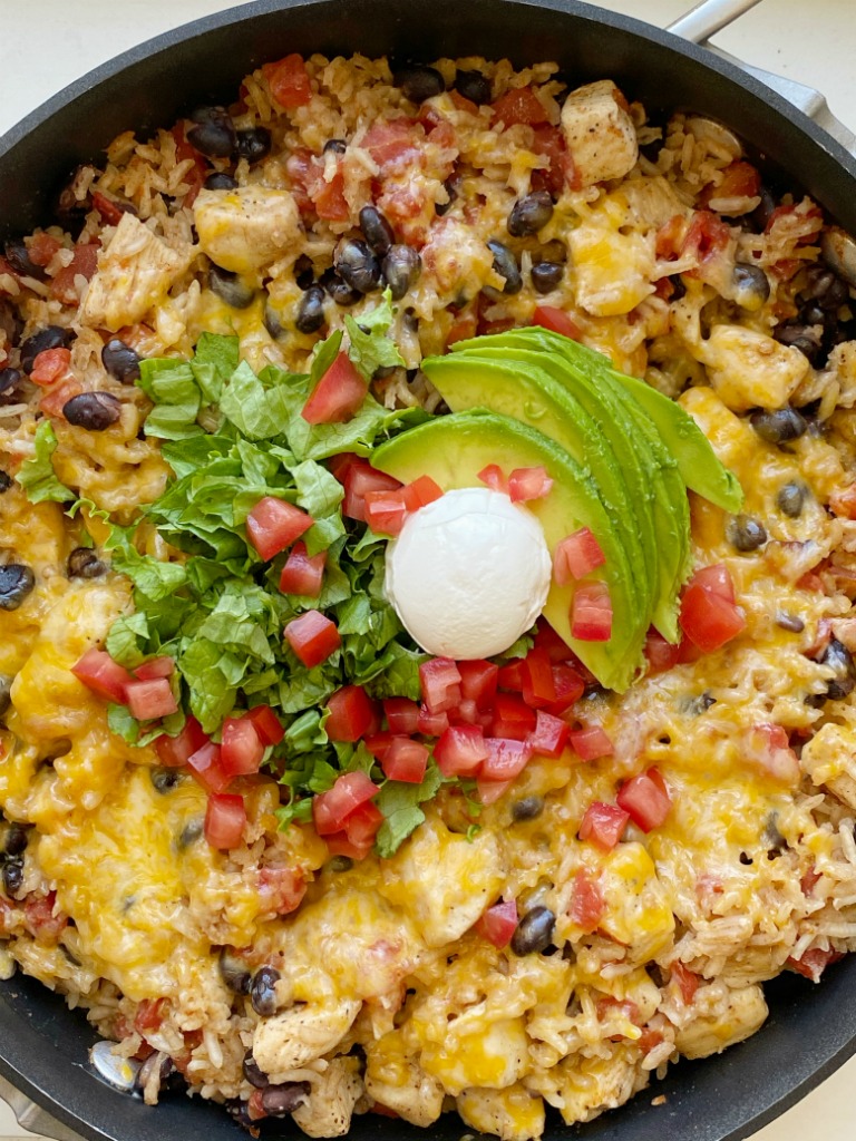 Chicken Burrito Skillet is a one pan easy dinner recipe that's made right on the stove top in 30 minutes. Chunks of chicken, rice, beans, and tomatoes simmer in seasoned chicken broth.