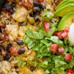 Chicken Burrito Skillet is a one pan easy dinner recipe that's made right on the stove top in 30 minutes. Chunks of chicken, rice, beans, and tomatoes simmer in seasoned chicken broth.