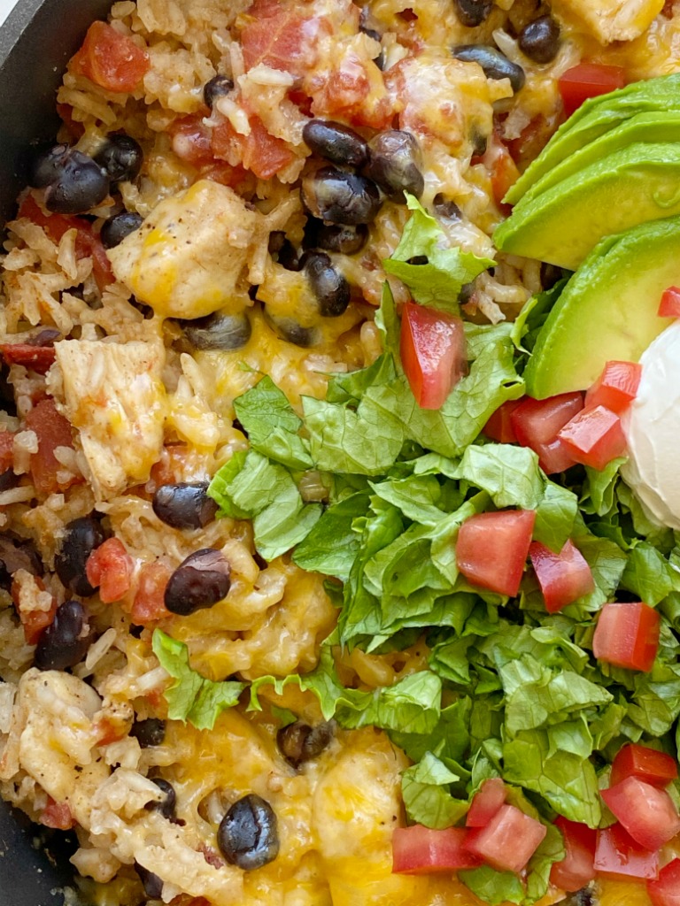 Chicken Burrito Skillet is a one pan easy dinner recipe that's made right on the stove top in 30 minutes. Chunks of chicken, rice, beans, and tomatoes simmer in seasoned chicken broth.