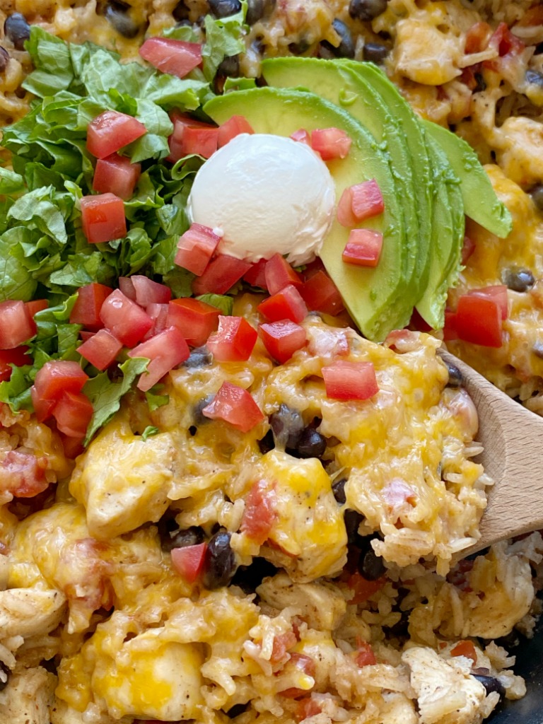 Chicken Burrito Skillet is a one pan easy dinner recipe that's made right on the stove top in 30 minutes. Chunks of chicken, rice, beans, and tomatoes simmer in seasoned chicken broth.