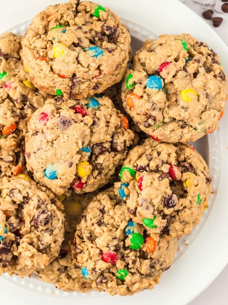 A white plate full of monster cookies.