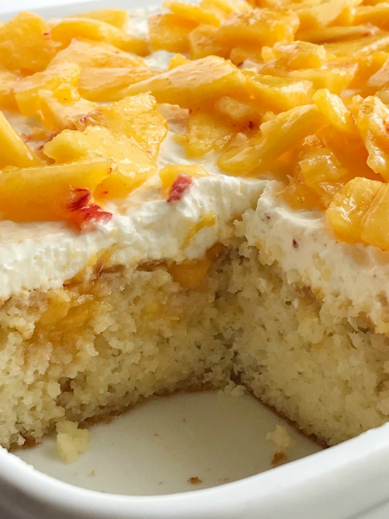 Peaches and Cream Poke Cake | Poke Cake Recipe | Cake | Dessert | If you love poke cakes then you must try this peaches and cream poke cake! French vanilla cake soaked in fresh peaches, frosted with a light and fluffy cream cheese whipped topping, and topped with chunked fresh peaches. #pokecake #cake #dessertrecipes #easydessertrecipe #peaches #peachrecipes