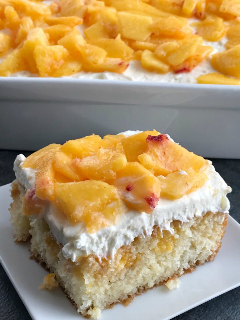 Peaches and Cream Poke Cake | Poke Cake Recipe | Cake | Dessert | If you love poke cakes then you must try this peaches and cream poke cake! French vanilla cake soaked in fresh peaches, frosted with a light and fluffy cream cheese whipped topping, and topped with chunked fresh peaches. #pokecake #cake #dessertrecipes #easydessertrecipe #peaches #peachrecipes