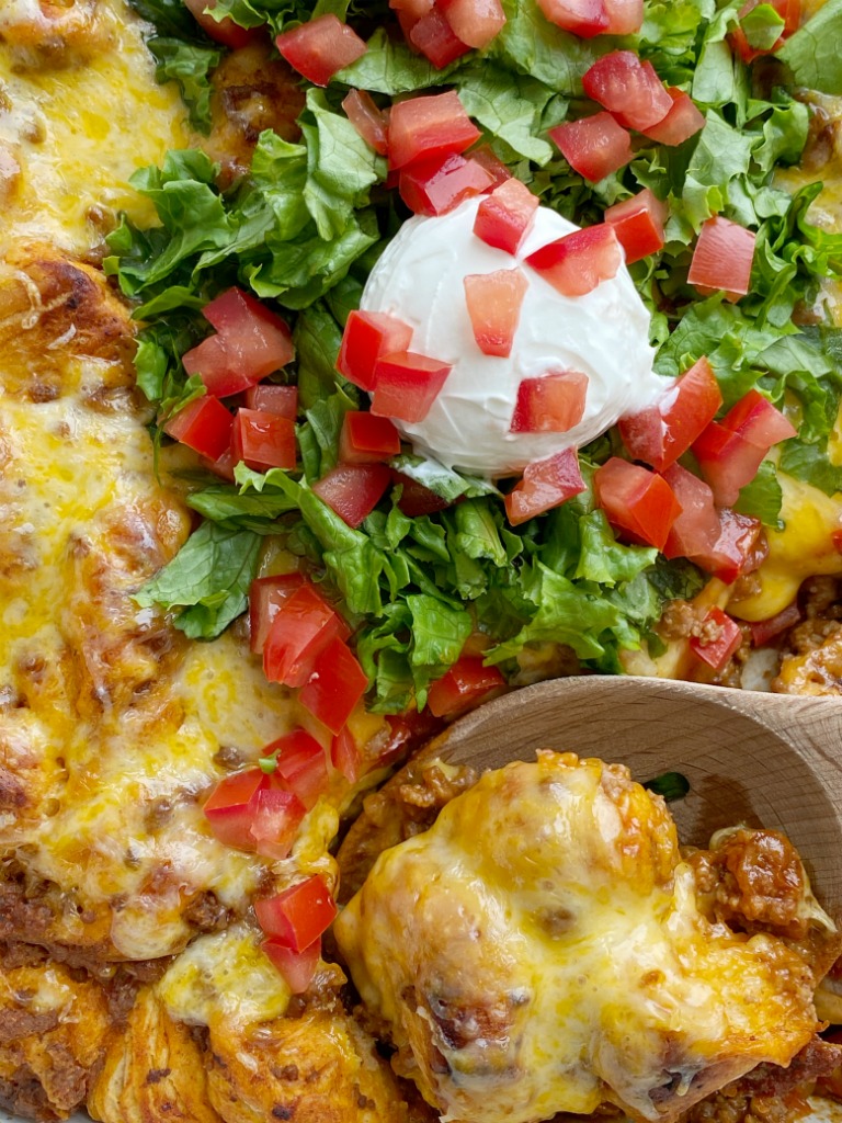 Taco biscuit bake is an easy & simple dinner recipe with refrigerated biscuit dough smothered in a beefy taco mixture and topped with melted cheese.