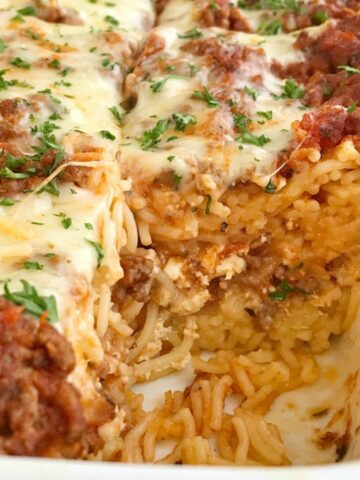 Baked Spaghetti Casserole is a family favorite dinner that's filled with pasta, cheese, and an easy semi-homemade ground beef meat sauce. This gets gobbled up even by the pickiest eaters when I make it for dinner. Serve with a salad and garlic bread for a delicious and heart family dinner. 