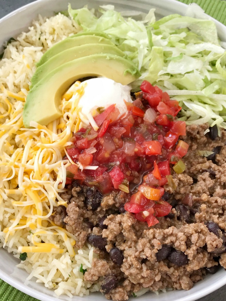 Beef Taco Burrito Bowls | Mexican Food | Dinner Recipe | Burrito Bowls | Beef taco burrito bowls are so easy to make at home! Seasoned beef taco meat with black beans, layered with rice, and all the taco toppings you want. Everyone can make their own for a fun, quick & easy, and delicious dinner. #dinnerrecipes #recipeoftheday #mexicanfood #burritobowls #groundbeef