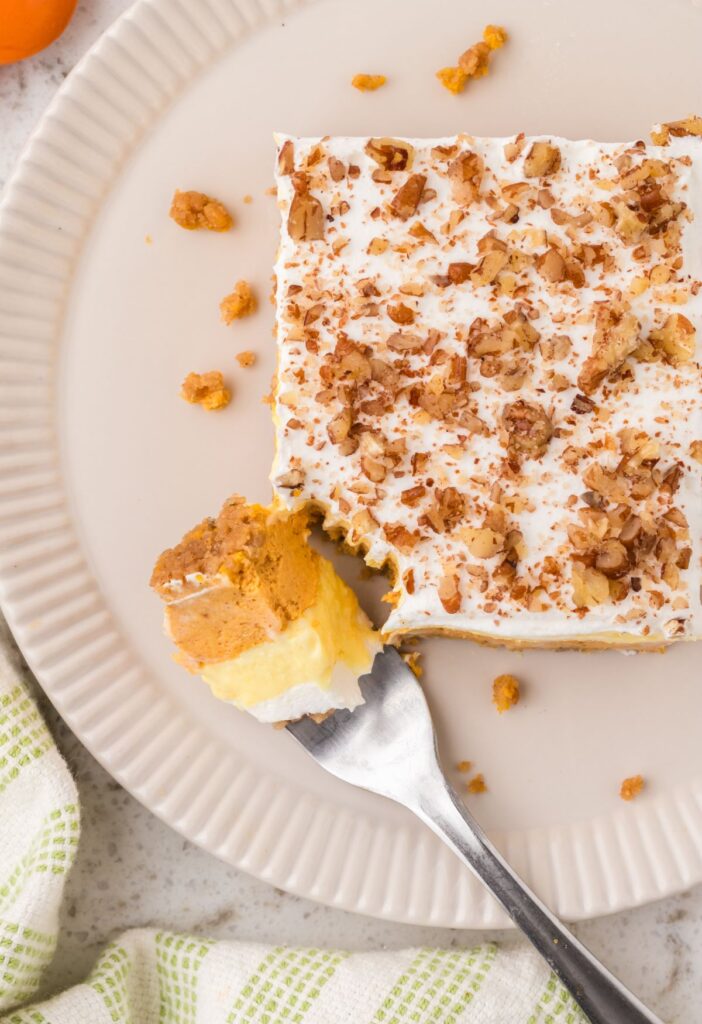 Top view of a slice of pumpkin cheesecake dessert with a fork.