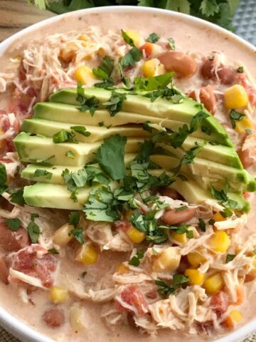 Creamy Southwest Chicken Chili | Slow Cooker | Crock Pot Chili | Chili Recipe | White Chicken Chili | Creamy chicken chili with southwest flavors that cooks right in the crock pot. Chicken breast, corn, pinto beans, ranch seasoning & spices combine in the slow cooker for an easy, simple family dinner. Serve with shredded cheese, avocado slices, and cilantro. #chili #chilirecipes #dinnerrecipe #chicken #slowcookerrecipes