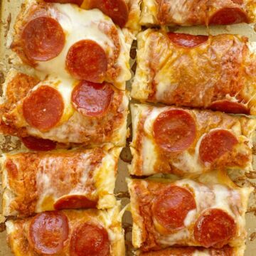 French Bread Pizza is perfectly crispy on the outside. No soggy pizza here! Topped with a jar of pizza sauce with added seasonings, pepperoni, and lots of cheese. It's a 30 minute dinner that's perfect for a busy weeknight meal.