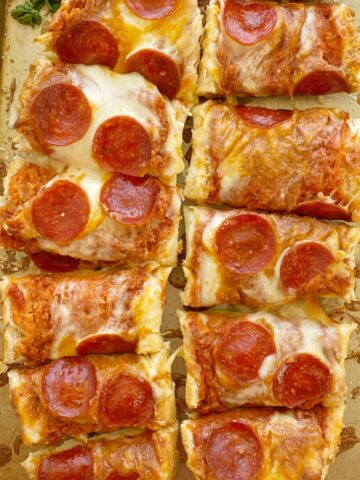 French Bread Pizza is perfectly crispy on the outside. No soggy pizza here! Topped with a jar of pizza sauce with added seasonings, pepperoni, and lots of cheese. It's a 30 minute dinner that's perfect for a busy weeknight meal.