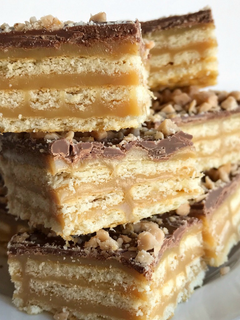 Triple Layer Cracker Toffee Bars | Toffee Recipe | Caramel Recipe | Cracker Toffee | These easy caramel & chocolate triple layer cracker toffee bars are a fun twist to traditional cracker toffee. One pan, three layers, and only about 10 minutes is all you need for sweet, buttery, salty perfection. It's a must make Christmas recipe! #holidayrecipe #christmasrecipe #dessert #easydessertrecipes #caramel #toffee #recipeoftheday