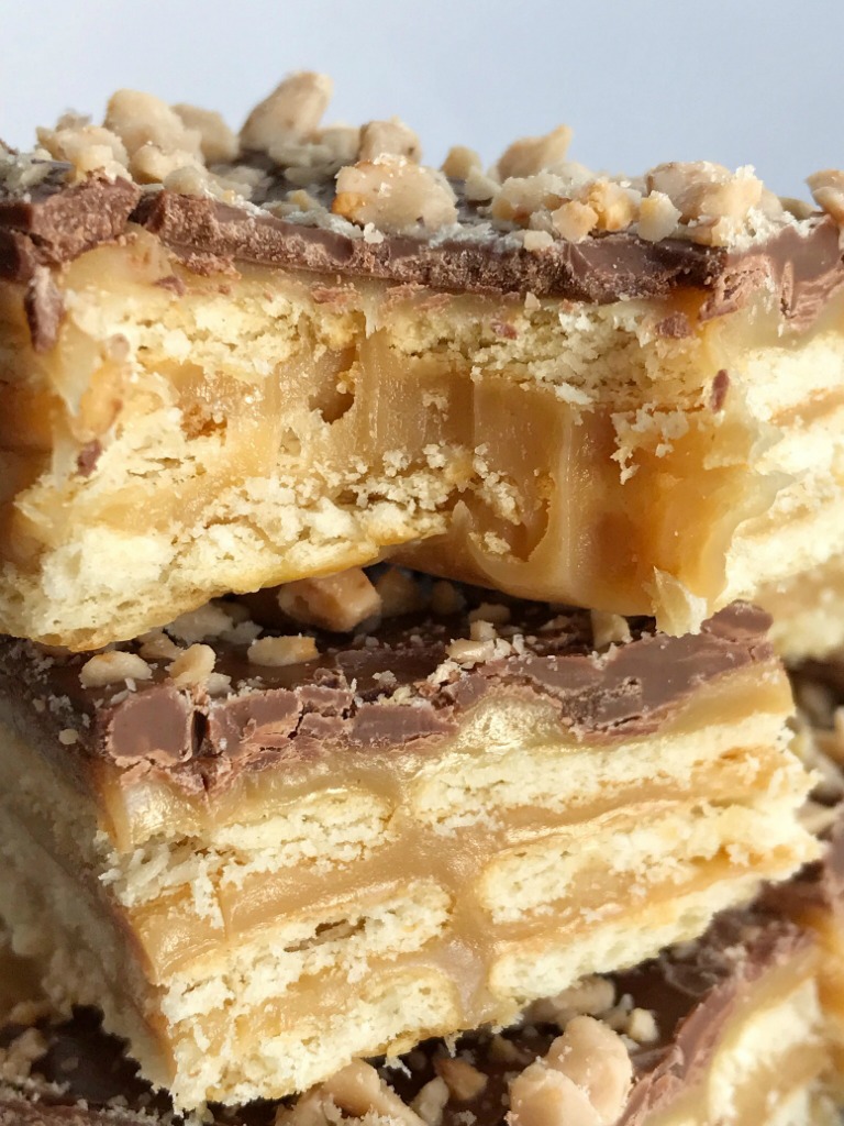 Triple Layer Cracker Toffee Bars | Toffee Recipe | Caramel Recipe | Cracker Toffee | These easy caramel & chocolate triple layer cracker toffee bars are a fun twist to traditional cracker toffee. One pan, three layers, and only about 10 minutes is all you need for sweet, buttery, salty perfection. It's a must make Christmas recipe! #holidayrecipe #christmasrecipe #dessert #easydessertrecipes #caramel #toffee #recipeoftheday