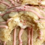 Soft baked white chocolate pudding peppermint cookies that are stuffed with a Hershey's candy cane kiss! These are the best Christmas cookies you'll ever have. Sweet, soft, thick, stuffed with a candy cane kiss, and drizzled with melted candy cane kisses.