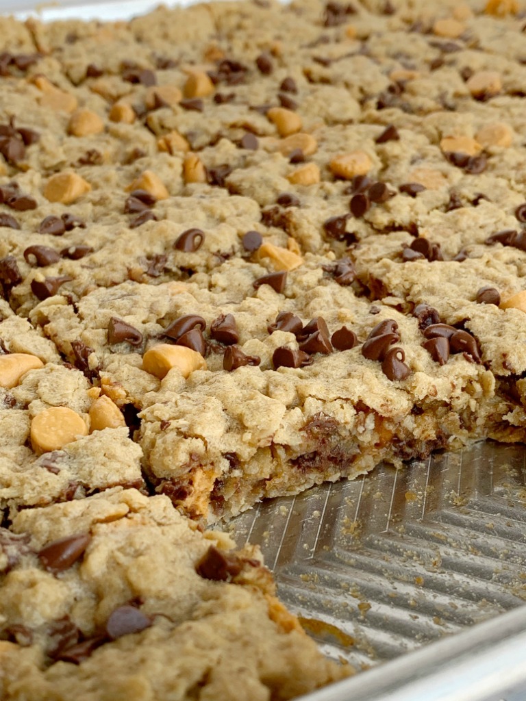 Chewy butterscotch peanut butter cookie bars have no flour! Hearty, chewy, soft baked, and loaded with chocolate and butterscotch chips. This cookie bar recipe makes lots of cookie bars so it's perfect for snacks (freeze extras) or big gatherings. 