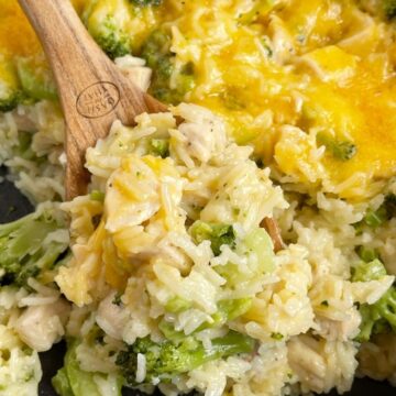 One scoop of chicken broccoli rice on a wooden spoon.