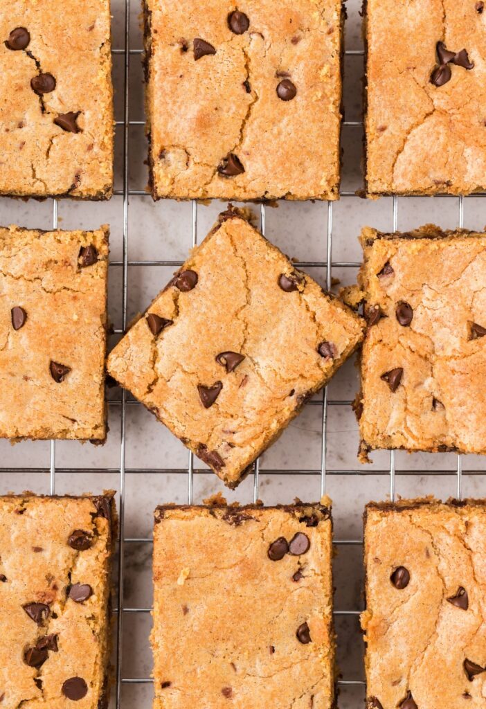 Chocolate chip blondies cut into squares sitting on a cooling rack.
