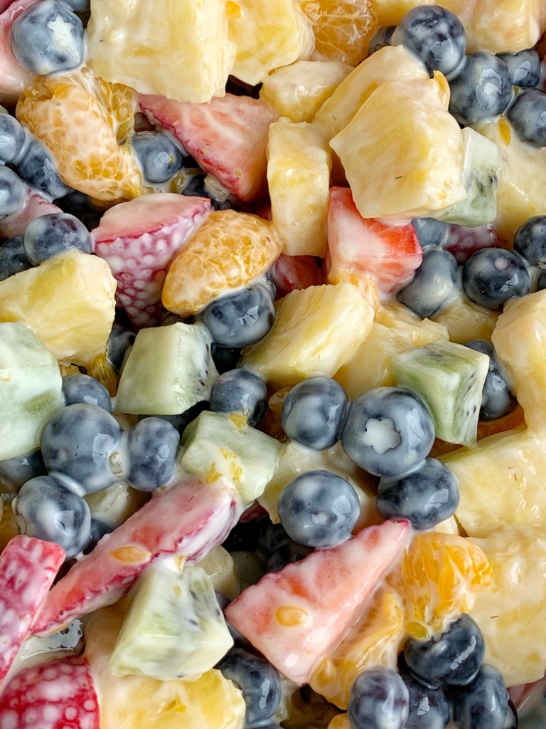 Lemon Yogurt Fruit Salad | Fruit Salad | Salad Recipe | Fruit salad with a creamy lemon yogurt dressing. Fresh pineapple, strawberries, blueberries, kiwi, and canned mandarin oranges are drizzled with a fresh lemon juice & lemon yogurt dressing. #fruitsalad #healthyrecipe #sidedish #summerrecipes #saladrecipes