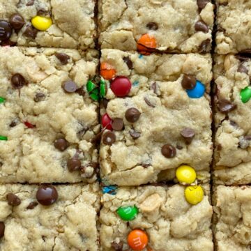 Monster cookie bars are a fun treat loaded with peanut butter, oats, chocolate chips, peanut butter chips, and mini m&m's. They bake up perfectly soft, chewy, and thick. A fun treat to make with the kids or great for back-to-school lunches or after school treat. 