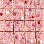 Valentines Day Sugar Cookie Bars | Sugar Cookie Bars | Valentines Dessert Recipes | Valentines day sugar cookie bars are the perfect sweet treat to celebrate with. Soft, thick sugar cookie bars frosted with the best pink frosting ever! Decorate with all your favorite Valentines candy and enjoy. #holidayrecipes #valentinesdayrecipes #valentinesday #dessert #sugarcookiebars