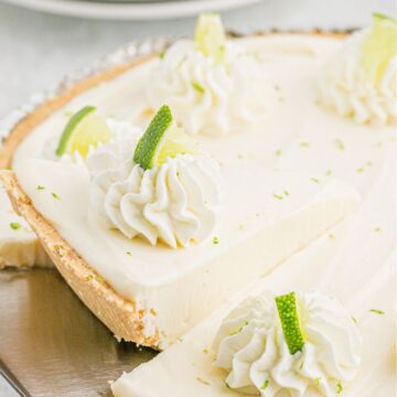 A no bake key lime with a pie tool holding a piece of it.