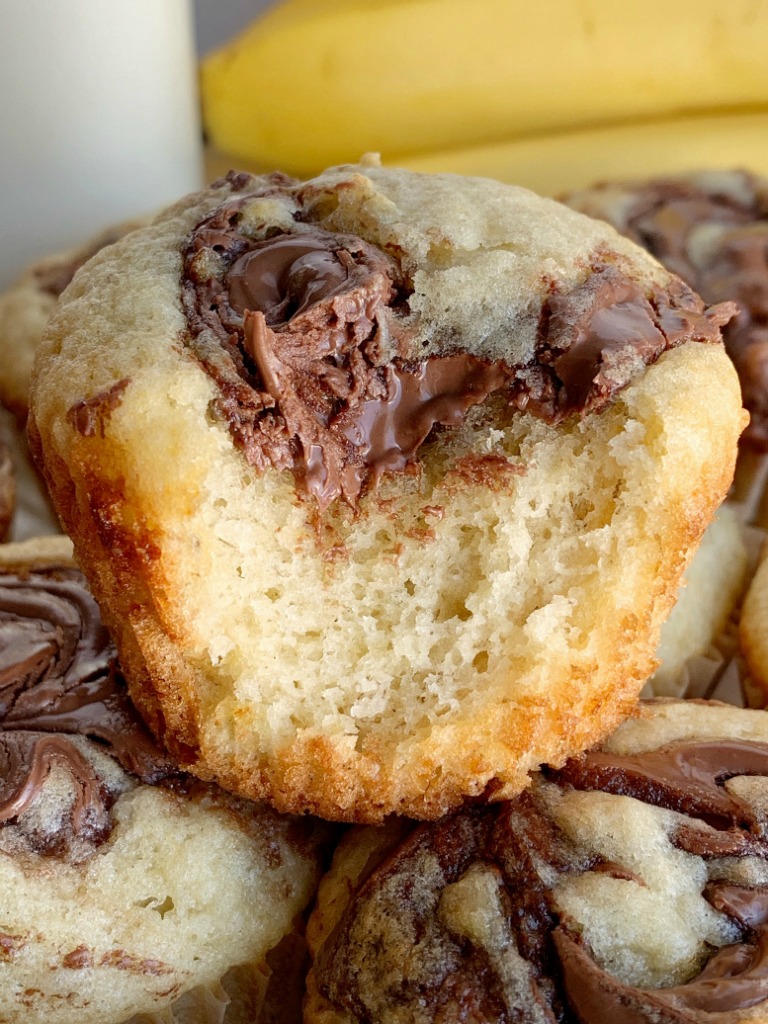 Nutella Swirl Banana Muffins | Banana Muffins | Nutella Recipes | Banana muffins with a sweet Nutella swirl on top! The perfect banana muffin recipe with Nutella. A great after school snack and a delicious way to use up those ripe brown bananas. #muffinrecipes #bananamuffins #snackideas #snackrecipes #recipeoftheday #easyrecipeideas