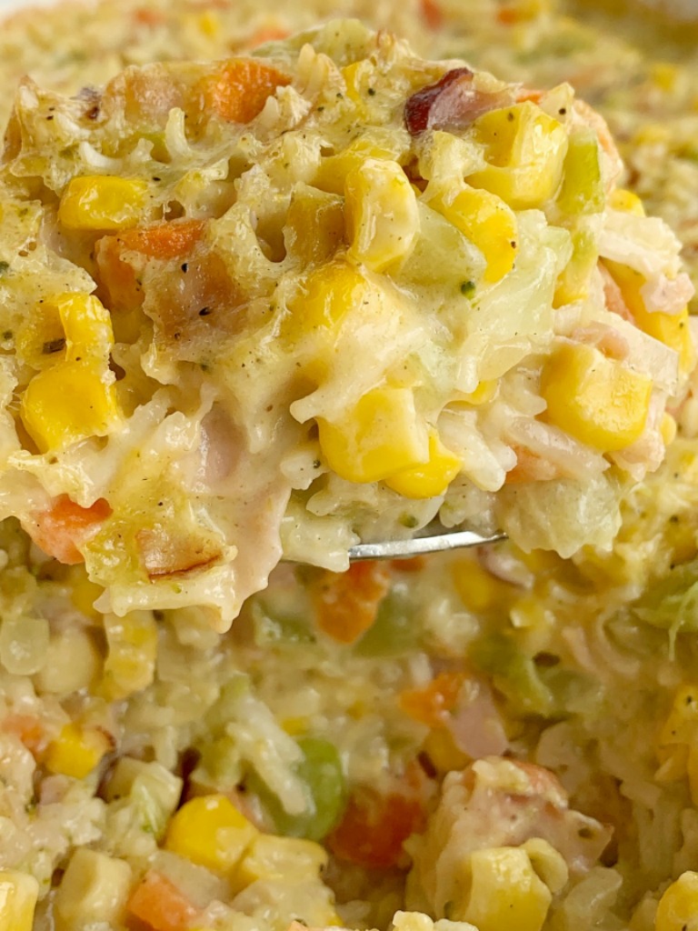 Ham & Broccoli Rice Casserole | Casserole Recipes | Casserole | Dinner Recipes | Broccoli Rice Casserole is loaded with flavorful rice, carrots, corn, chopped ham, and cheese. This rice casserole is a great way to use up leftover ham, bakes up in one pan, and it's a family favorite. #casserole #dinnerrecipes #dinner #recipeoftheday