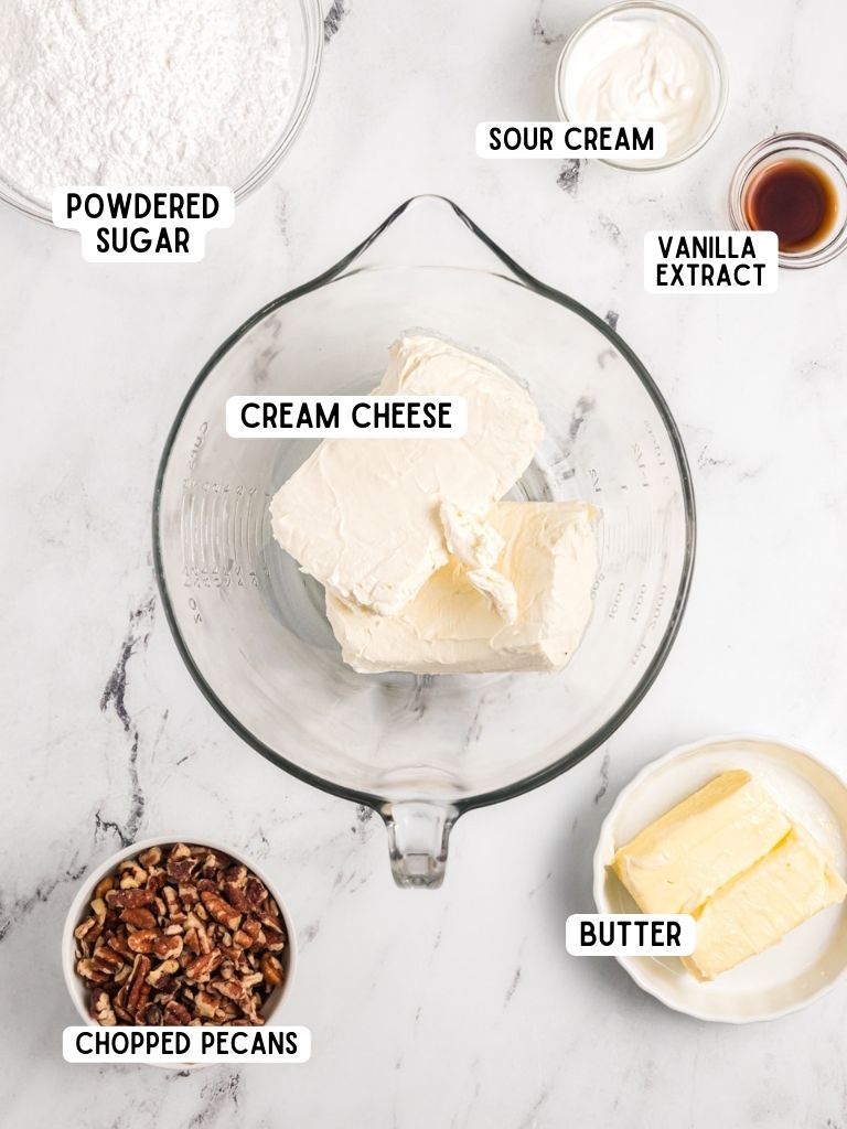 Ingredients needed to make cream cheese frosting with each one labeled in black text.