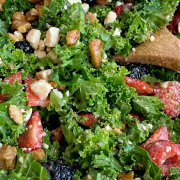 Citrus Berry Kale Salad | Kale Salad | Healthy Salad Recipe | Kale Salad with fresh strawberries, raspberries, and blackberries! Topped with feta cheese, glazed walnuts and a super simple homemade citrus olive oil dressing. This salad can make anyone a kale fan. #kalesalad #kalerecipes #healthyrecipes #salad #sidedish #saladrecipes #recipeoftheday #summerrecipes