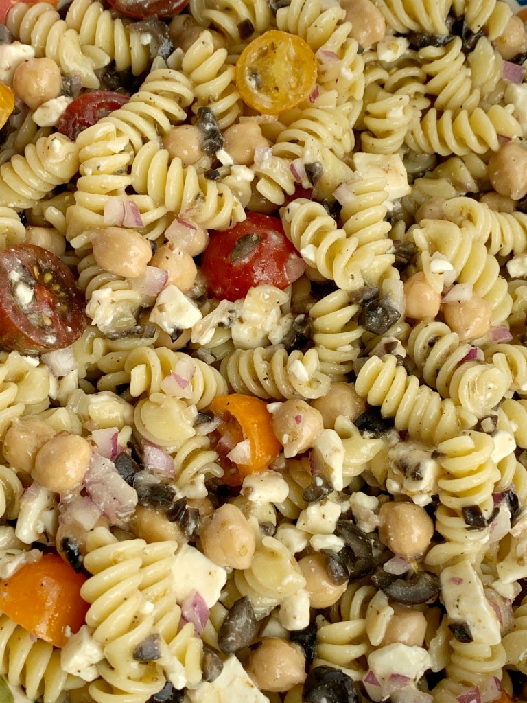 Greek Pasta Salad | Pasta Salad Recipes | Easy Greek Pasta Salad with tender spiral pasta, feta cheese, black olives, cherry tomatoes, red onion, and chickpeas with a easy dressing of Greek Vinaigrette salad dressing. So much flavor and texture, it's sure to be a hit. #salad #pastasalads #greek #sidedish #summerrecipes #pastasaladrecipes #recipeoftheday