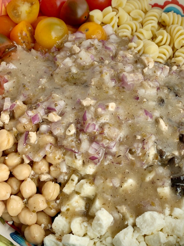 Greek Pasta Salad | Pasta Salad Recipes | Easy Greek Pasta Salad with tender spiral pasta, feta cheese, black olives, cherry tomatoes, red onion, and chickpeas with a easy dressing of Greek Vinaigrette salad dressing. So much flavor and texture, it's sure to be a hit. #salad #pastasalads #greek #sidedish #summerrecipes #pastasaladrecipes #recipeoftheday