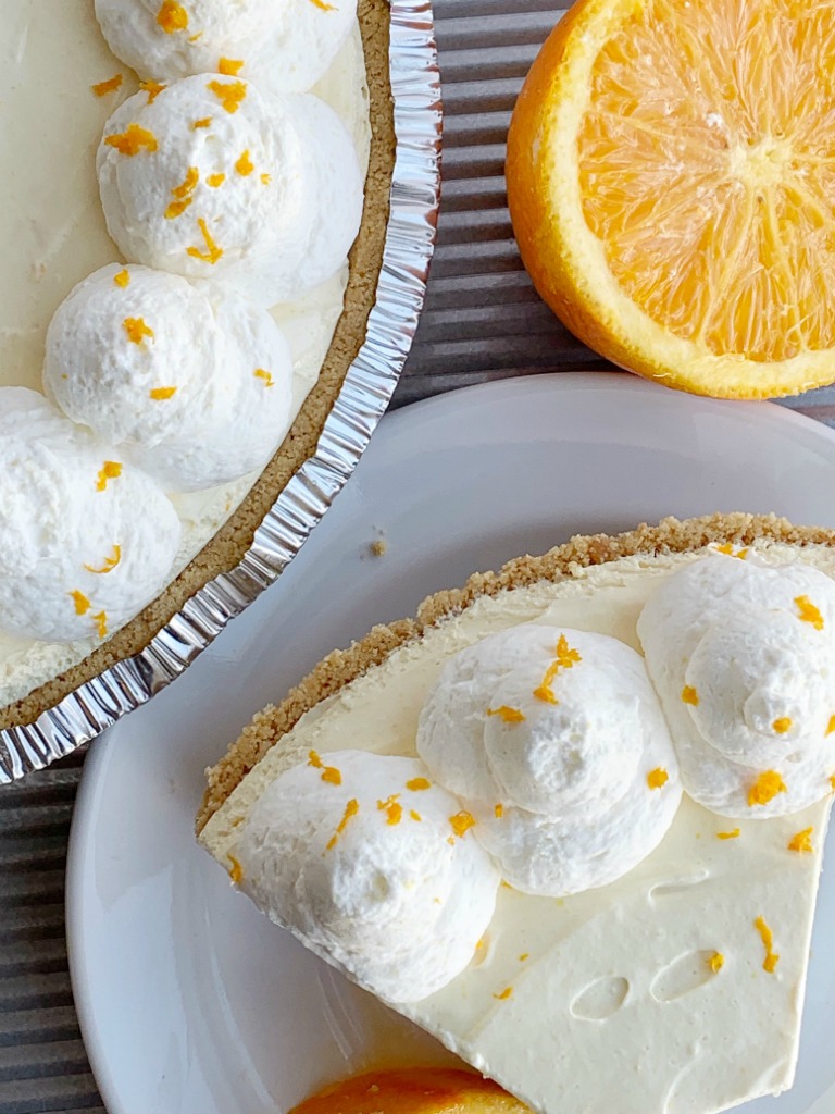 No Bake Orange Creamsicle Pie | No Bake Dessert | Pie | Orange Creamsicle Pie is a no bake dessert that is so refreshing and full of sweet orange cream flavor. Made easy with a prepared graham cracker crust, a sweet cream layer, and a light & fluffy orange layer with fresh orange juice and orange zest. #nobake #nobakepies #dessertrecipe #pies #summerrecipe #orangecreamsicle #easyrecipe #recipeoftheday 
