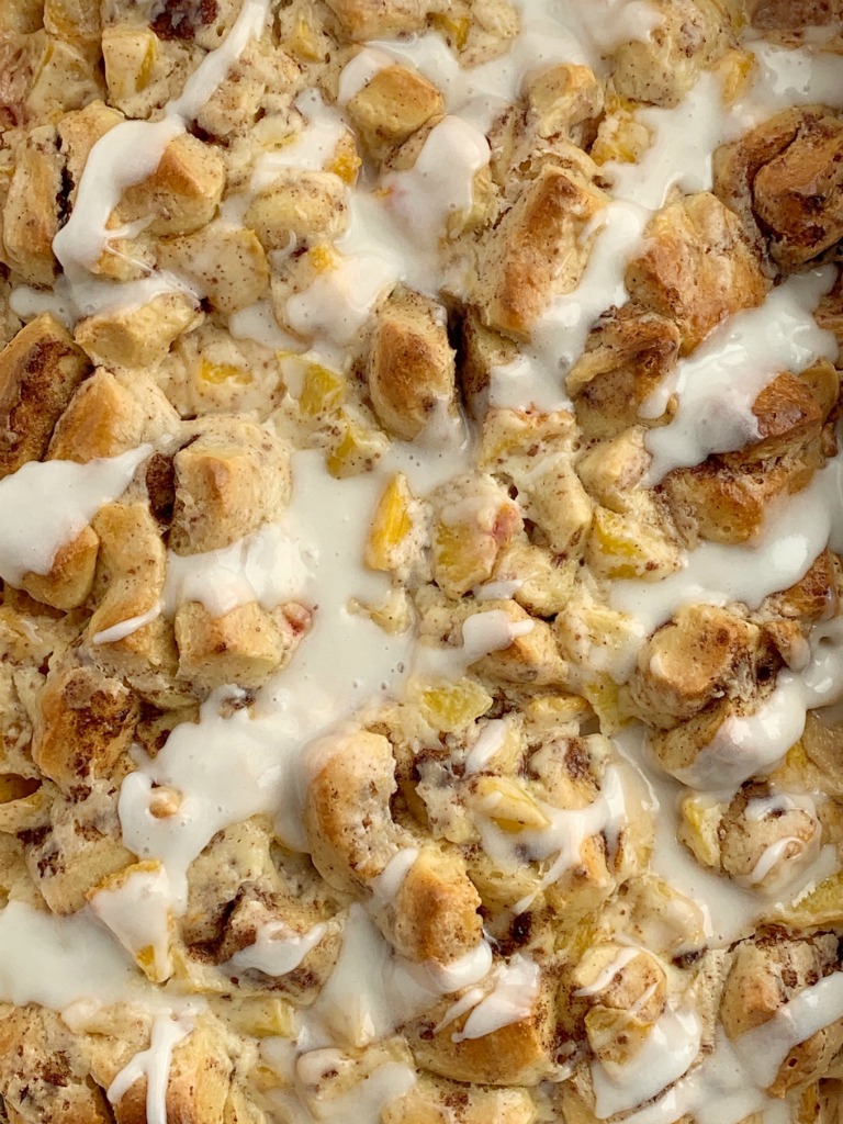 Peaches n' Cream Cinnamon Roll Casserole | Cinnamon Roll Casserole | Breakfast Recipes | Cinnamon Roll Casserole with peaches n' cream. Frozen peaches, cream cheese, powdered sugar, and cinnamon rolls combine to create the best sweet breakfast treat. Only 4 ingredients needed! #breakfastrecipes #casserole #cinnamonrolls #peaches #breakfastcasserole #recipeoftheday 