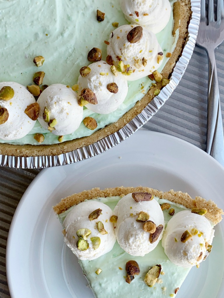 No Bake Pistachio Cheesecake Pie | Pistachio Cheesecake | No Bake Pie Recipe | No Bake Desserts | Pistachio Cheesecake Pie is no bake and so simple to make! Graham cracker crust with three layers of creamy, fluffy pistachio pudding filling. #nobakerecipes #nobake #nobakedesserts #pie #pistachio #easydessertrecipes #recipeoftheday #summerrecipes #holidayrecipes