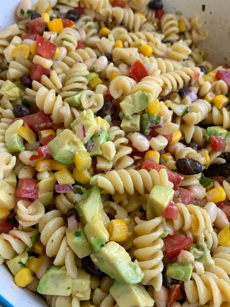 Cowboy Caviar Pasta Salad | Pasta Salad Recipe | Cowboy Caviar | Everyone's favorite Cowboy Caviar dip made into an easy Pasta Salad. Tender spiral pasta noodles, corn, sweet bell peppers, diced tomatoes, red onion, cilantro, avocado covered in Italian dressing and seasonings. #pastasalads #sidedishrecipe #cowboycaviar #summerrecipes #recipeoftheday #pastasaladrecipe