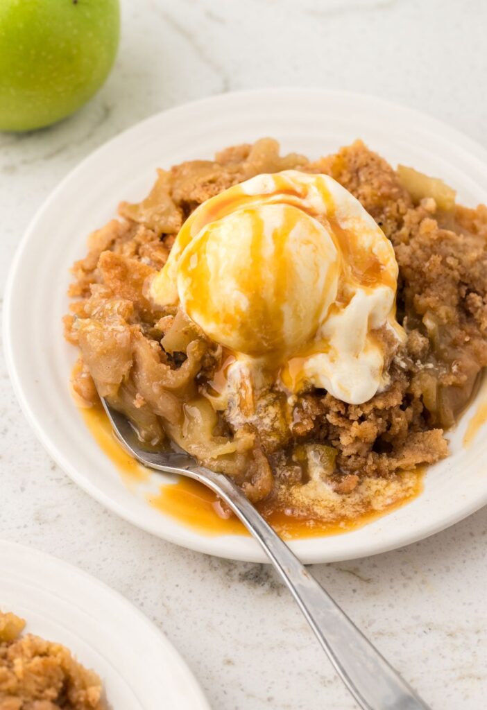 Serving of apple cobbler with ice cream on top