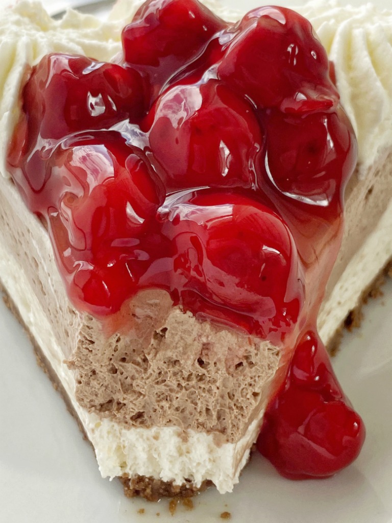 No Bake Black Forest Pie has a chocolate cookie crust with two layers of smooth cheesecake. Top with a spoonful of canned cherry pie filling.