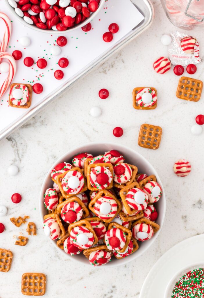 Bowl of peppermint pretzel bites with red and white m&m's. 