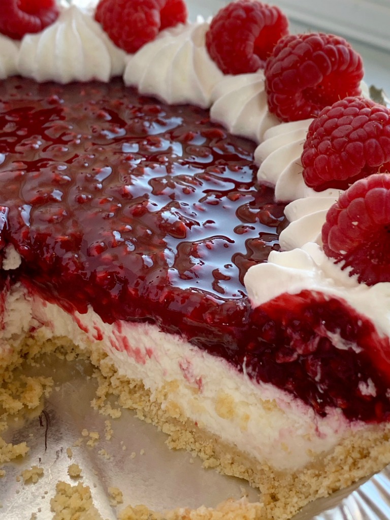 Raspberry Cream Pie has a sweet, cheesecake layer topped by a fresh raspberry layer inside an easy and convenient store-bought graham cracker crust!