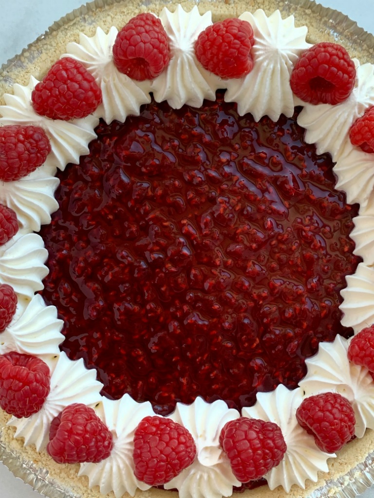 Raspberry Cream Pie has a sweet, cheesecake layer topped by a fresh raspberry layer inside an easy and convenient store-bought graham cracker crust!