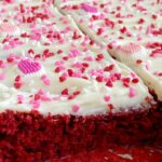 Easy Red Velvet Sheet Cake is so simple to make! A doctored up red velvet cake mix topped with the best, and fluffiest white chocolate cream cheese frosting.