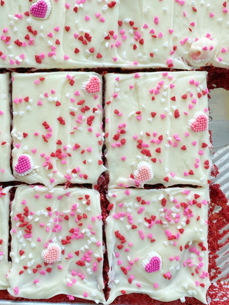 Easy Red Velvet Sheet Cake is so simple to make! A doctored up red velvet cake mix topped with the best, and fluffiest white chocolate cream cheese frosting.