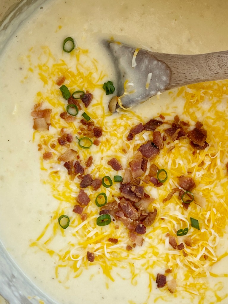 Potato Corn Chowder made in the Instant Pot! Frozen corn, chopped potatoes, and cheese in a creamy chicken broth base. Serve with shredded cheese, bacon, and green onions.