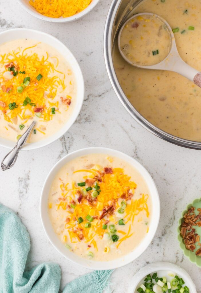 Insert of the instant pot with chowder in it and a serving bowl of it next to it.