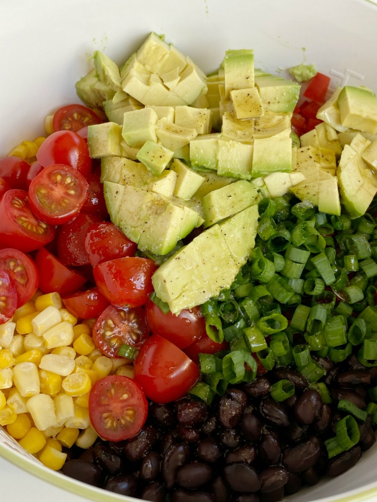 AVOCADO BLACK BEAN SALAD is a healthy and fresh salad with avocados, black beans, corn, red pepper, green onion, and tomatoes. The easy homemade honey lime vinaigrette is the best part!