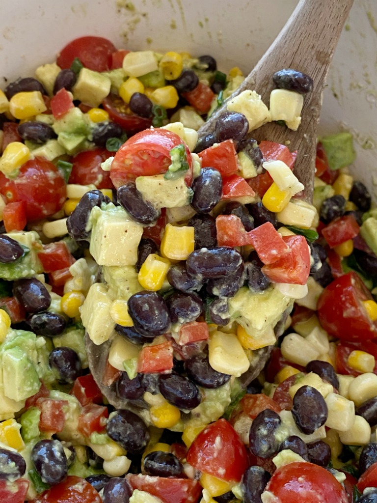 AVOCADO BLACK BEAN SALAD is a healthy and fresh salad with avocados, black beans, corn, red pepper, green onion, and tomatoes. The easy homemade honey lime vinaigrette is the best part!