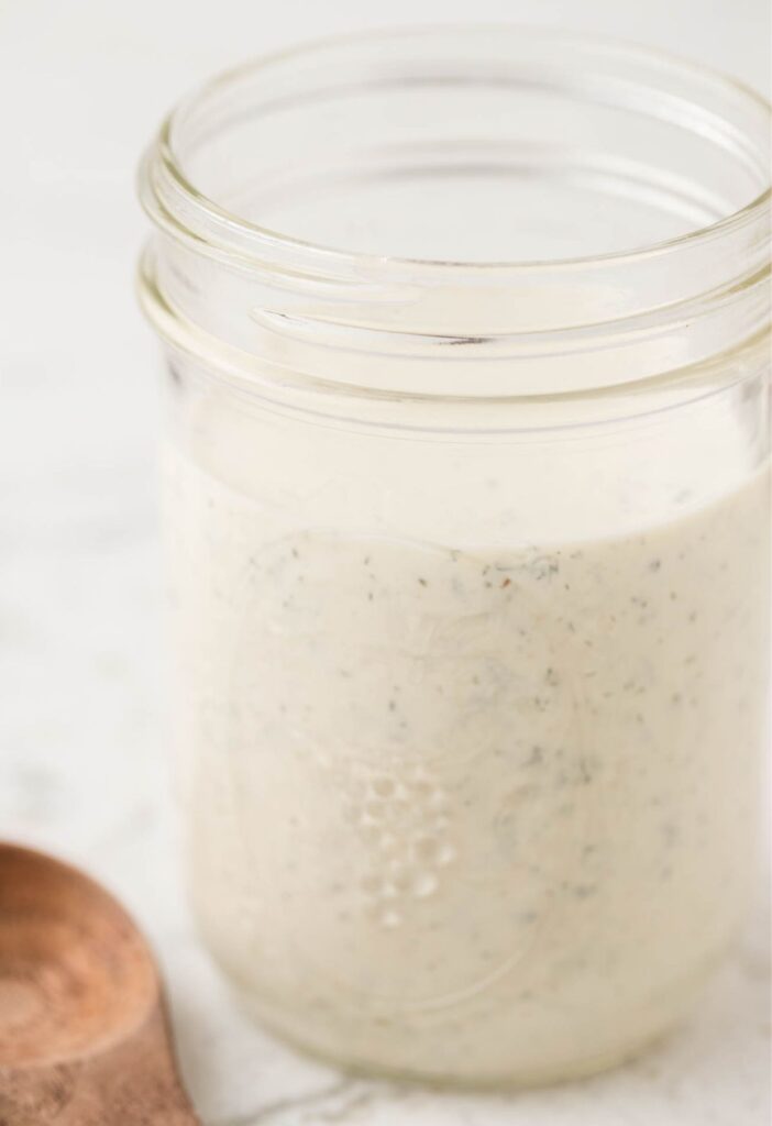 A glass jar of ranch dressing